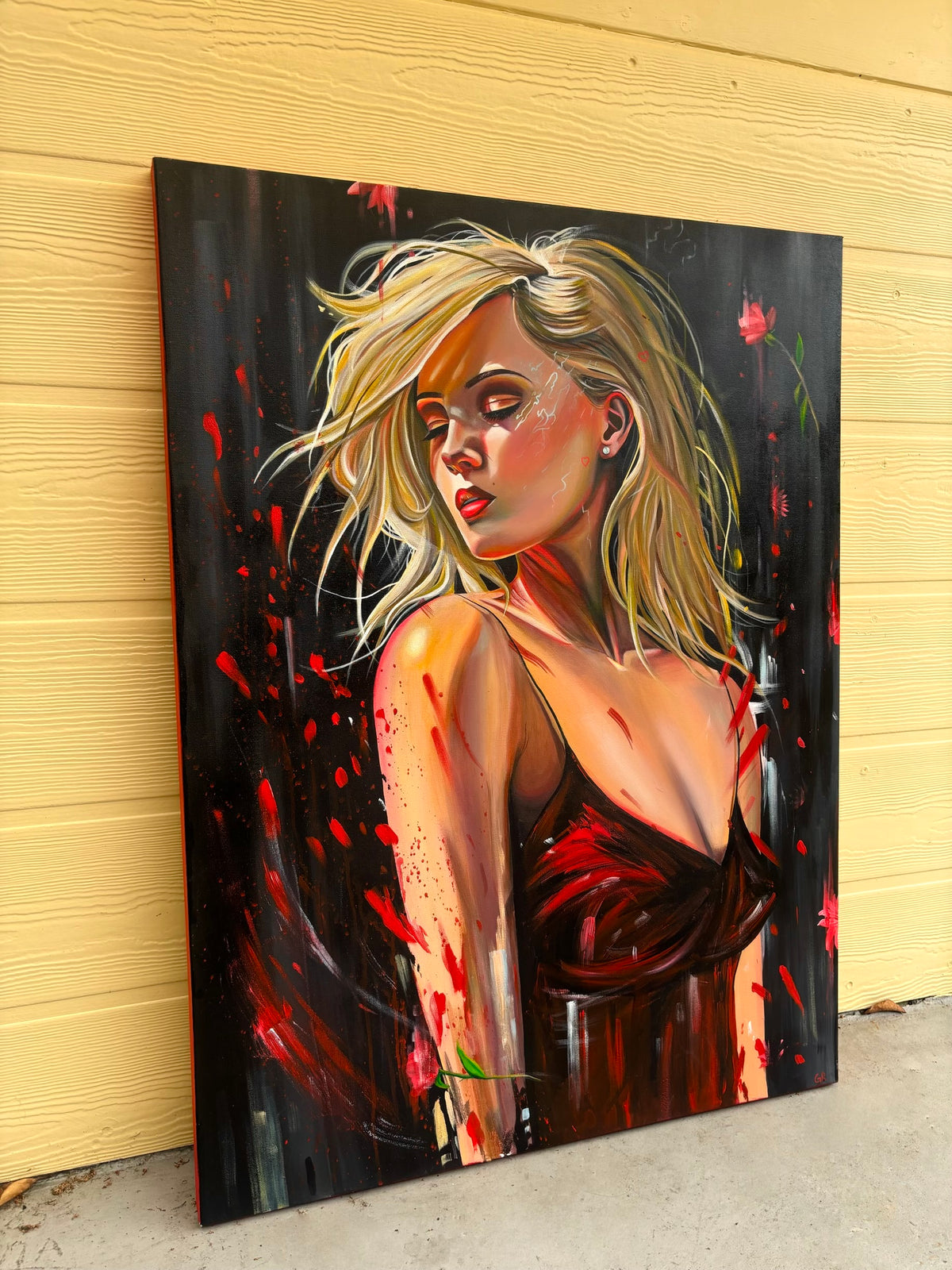 Painting of a woman with blonde hair and tattoos on a black background with red accents, leaning against a yellow wall.