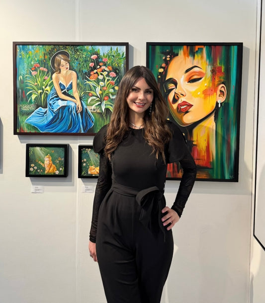 Gracey Ripa standing in front of her artwork at an art exhibition